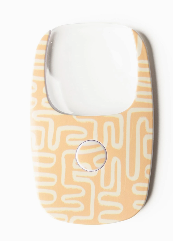 credit card size magnifying glass with LED light, small push button to activate light.
creamy light orange background with abstract cream squiggly line design