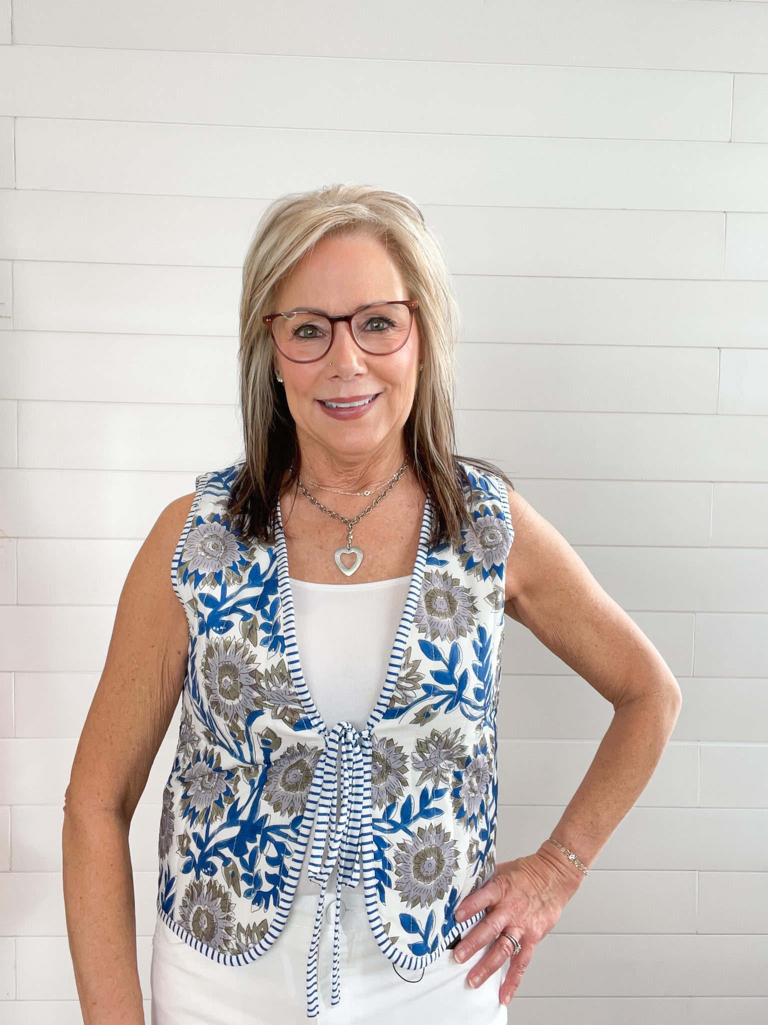 women's vest with single tie in the center, blue and beige floral print on white background