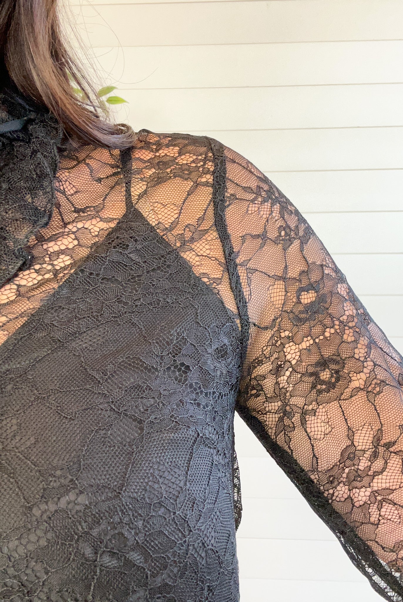 Close-up of a black lace garment with floral patterns.