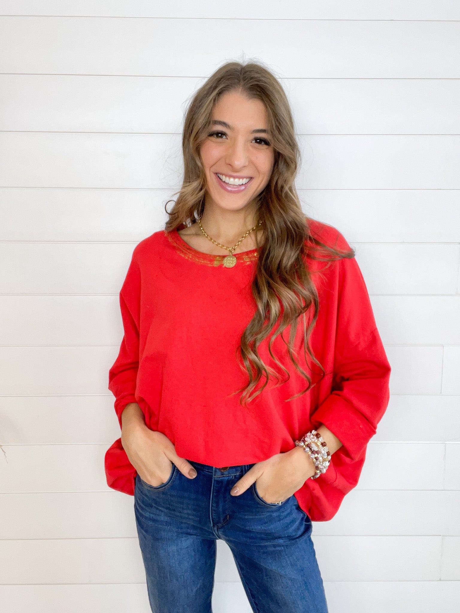 oversized lightweight top with half length sleeves, foil detail at the neckline.
Red body, gold detail