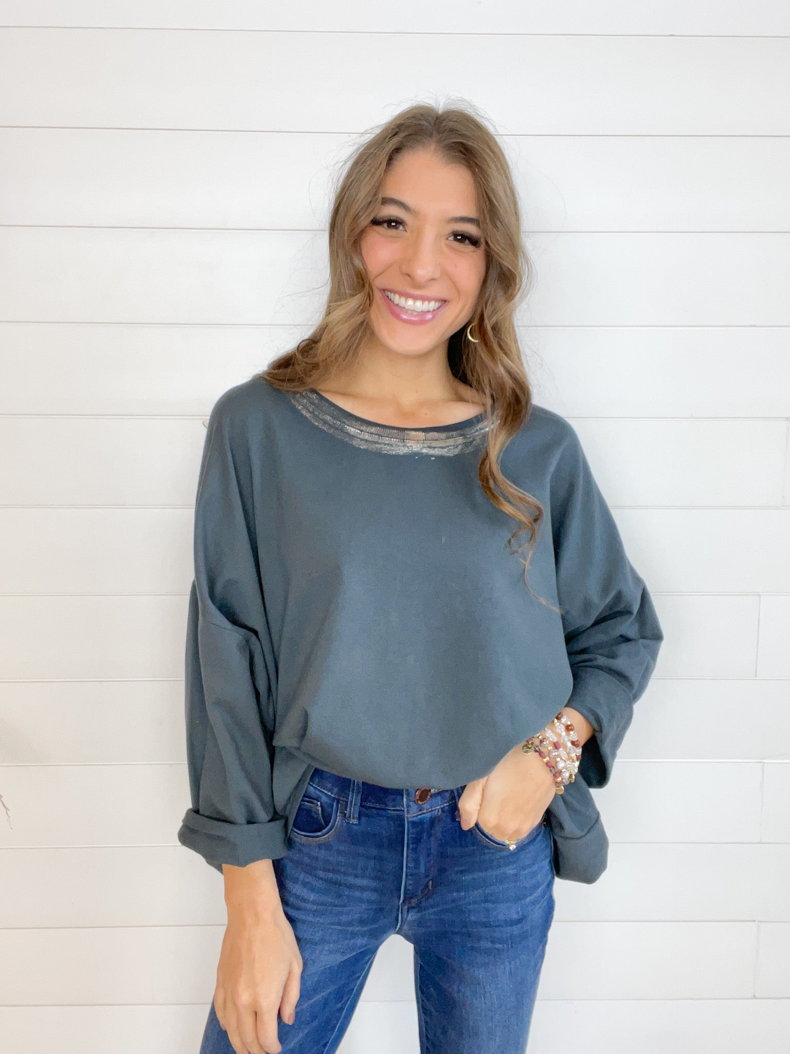 oversized lightweight top with half length sleeves, foil detail at the neckline.
Grey body, silver detail