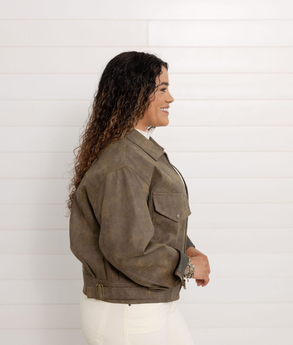 Woman wearing a brown jacket against a white background