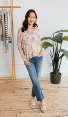 Designed with a relaxed fit, it features a flattering V-neckline and a lightweight waffle-knit texture that ensures breathability and comfort. The soft hues and botanical-inspired print make this sweater perfect for transitioning seasons, abstract warm pastel floral design