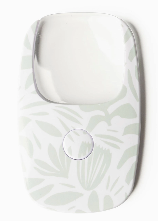 credit card size magnifying glass with LED light, small push button to activate light. 
white background with light sage green floral designs.