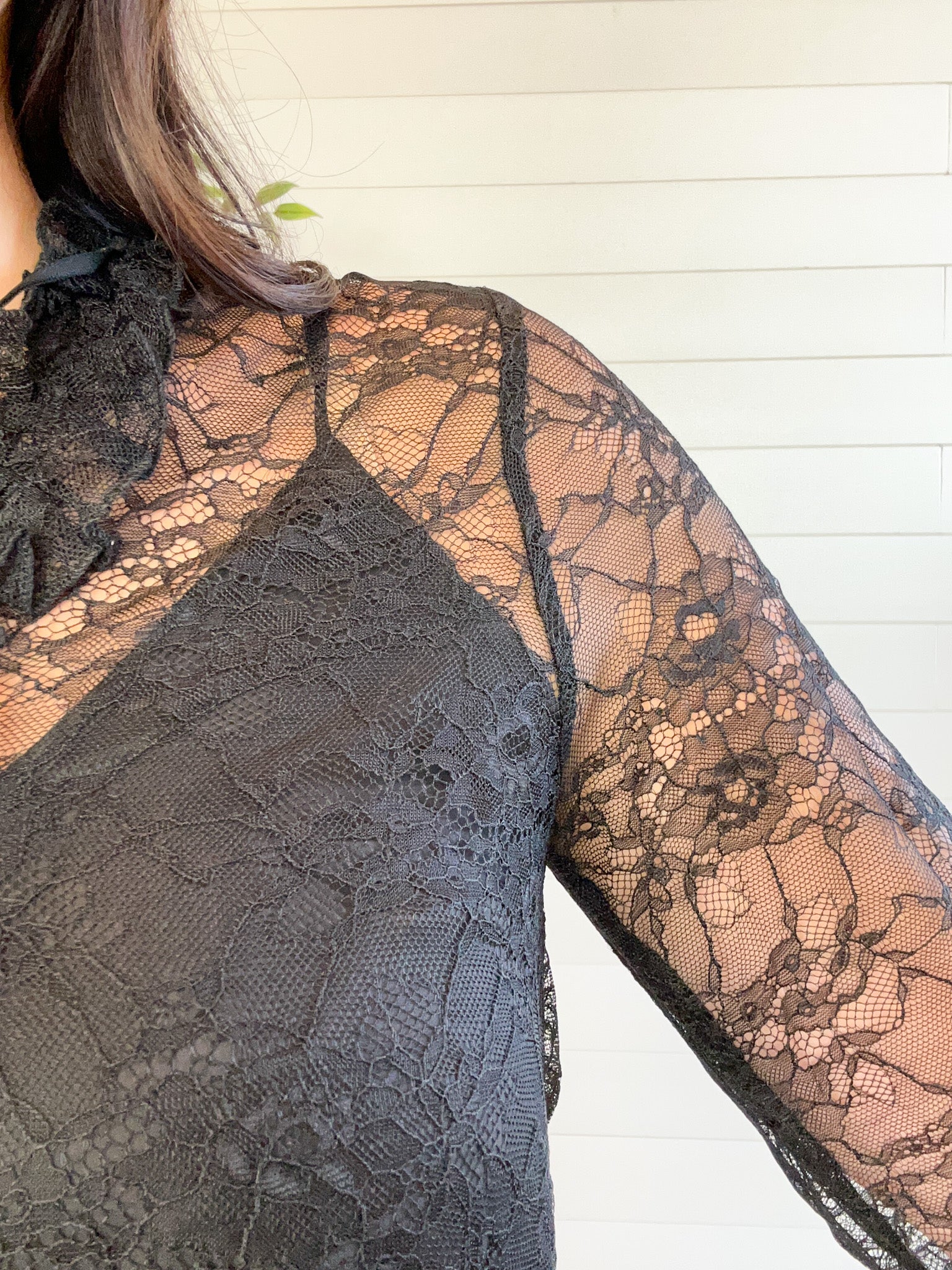 Close-up of a black lace garment with floral patterns.