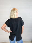 women's fashion top, wide neckline, smocked waist, drop shoulder, and center-split hem on the back