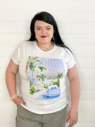 women's fashion tee featuring a graphic of a road lined with walk trees, ladies walking down the side walk, and a vintage car, with the word "Florida" across the top
