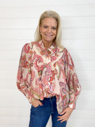 The Paisley Printed Long Sleeve Blouse combines elegance and comfort with its intricate paisley print and lightweight fabrication. Designed with a rounded neckline, button-down front, and added pleats for detail, this blouse is perfect for both casual and dressy occasions. Its relaxed fit and bubble sleeve effect create a flattering, effortlessly chic look.