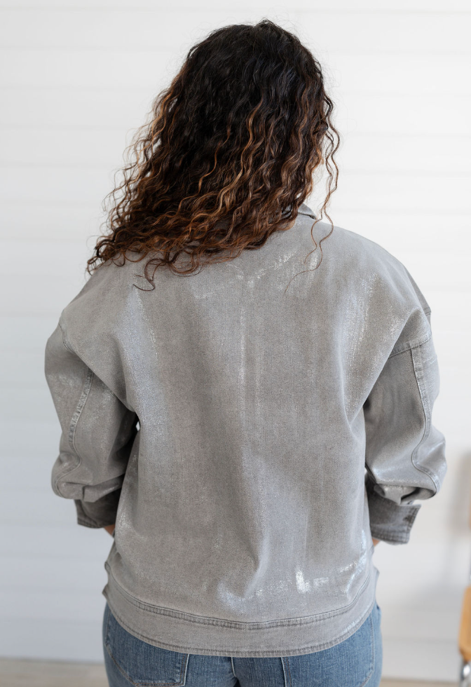 Person wearing a gray jacket from behind with a white background