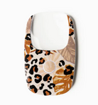 credit card size magnifying glass with LED light, small push button to activate light. 
cream background with black and shades of brown leopard spots and palm fronds
