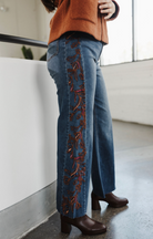 embroidered denim, fall fashion trends, denim trends, women's clothing, red embroidered jeans